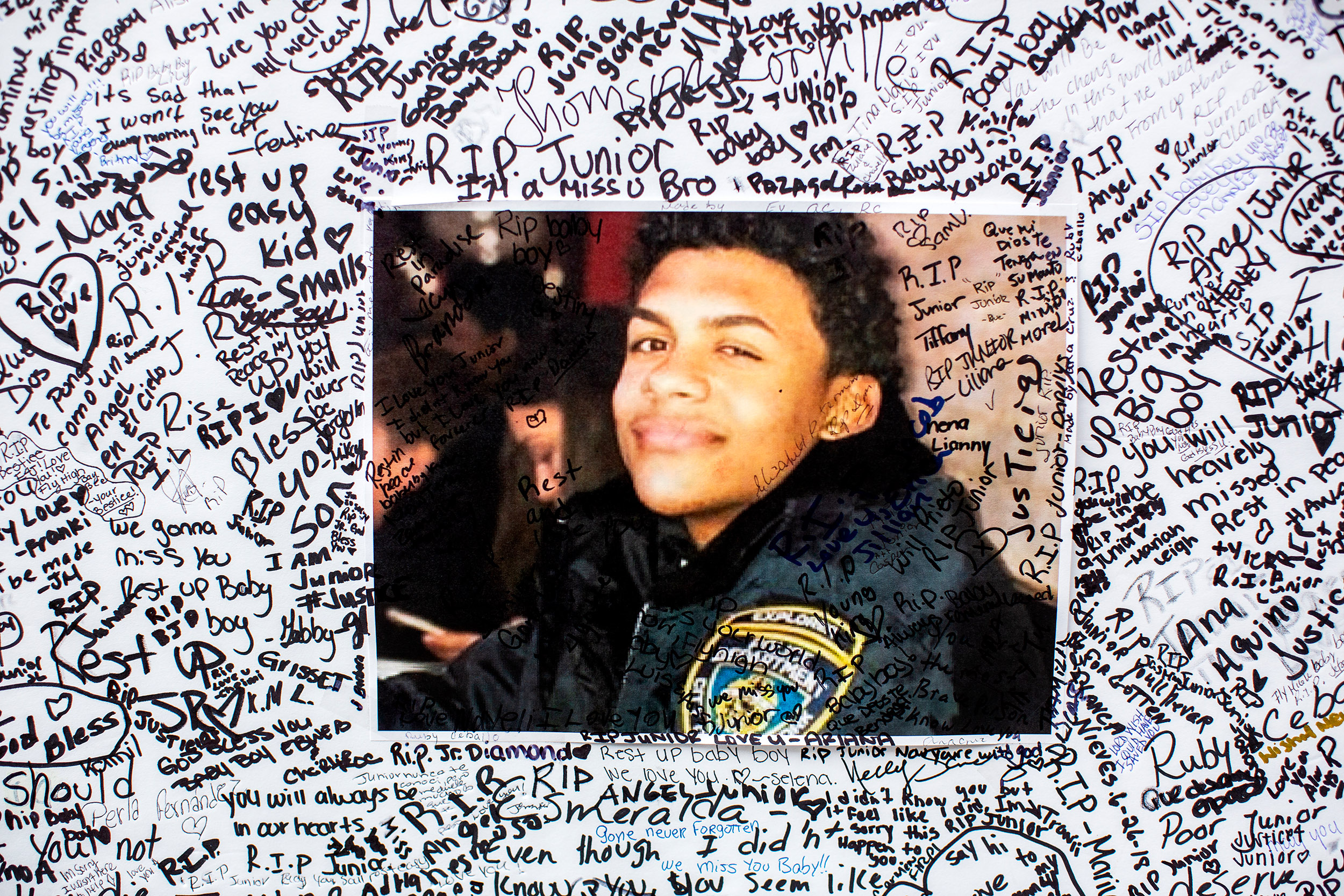  A poster of Lesandro Guzman-Feliz covered with messages from mourners. 