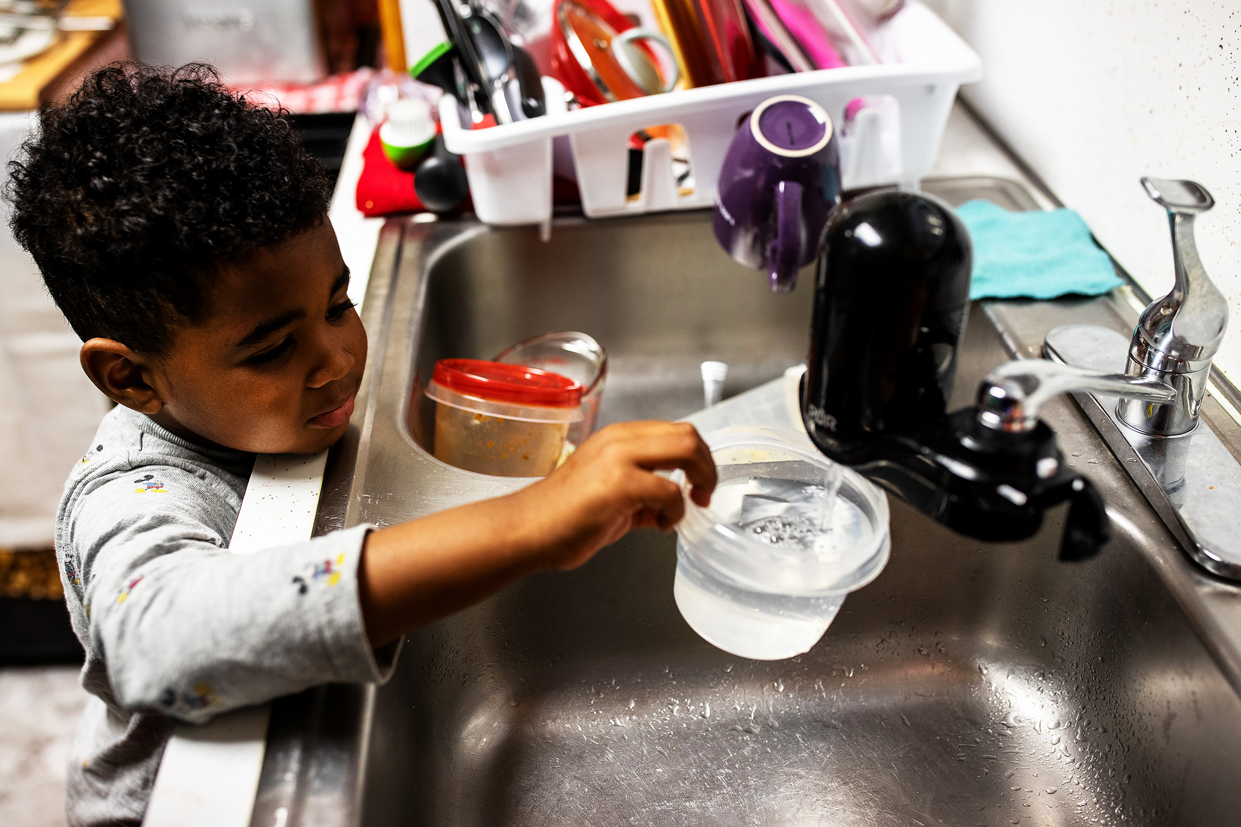  Thomas’s son, Bryce, uses the water filter in the family kitchen. Lead levels in the water of their home measured a staggering 76.2 parts per billion in February 2019. 