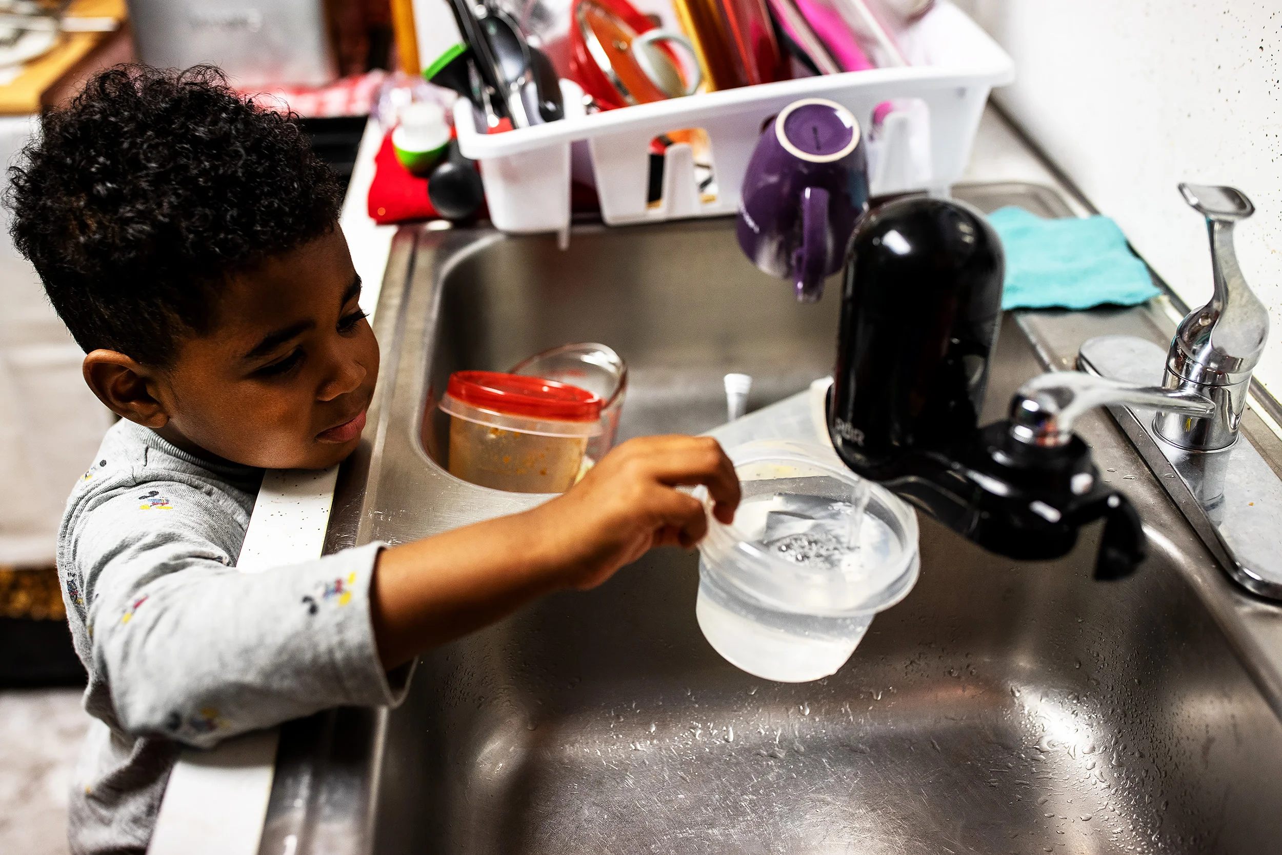 Thomas’s son, Bryce, uses the water filter in the family kitchen. Lead levels in the water of their home measured a staggering 76.2 parts per billion in February 2019.