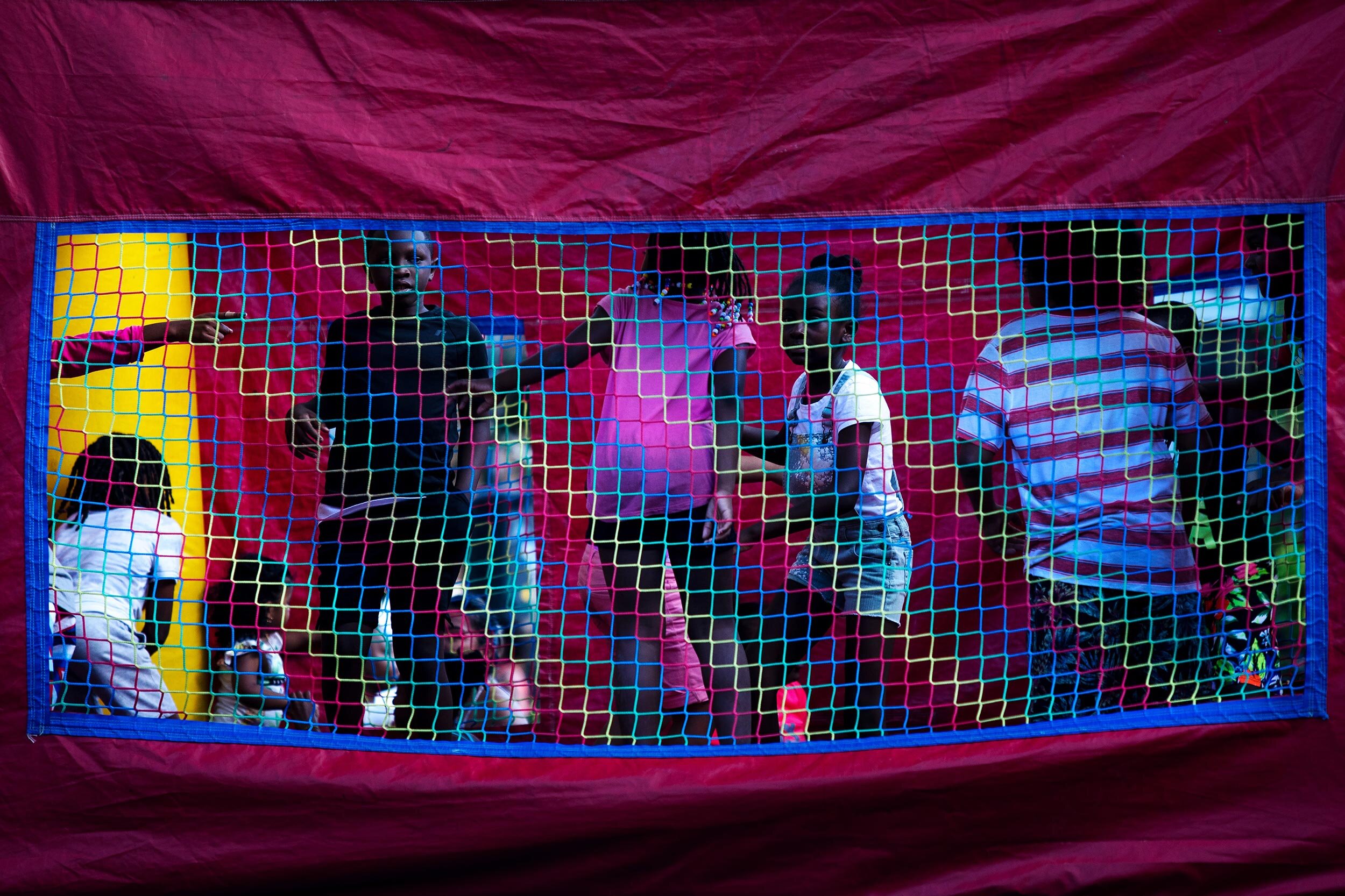   Children play in a bounce pay house at the Avenue D and East 38 Block Party in Brooklyn, New York.  