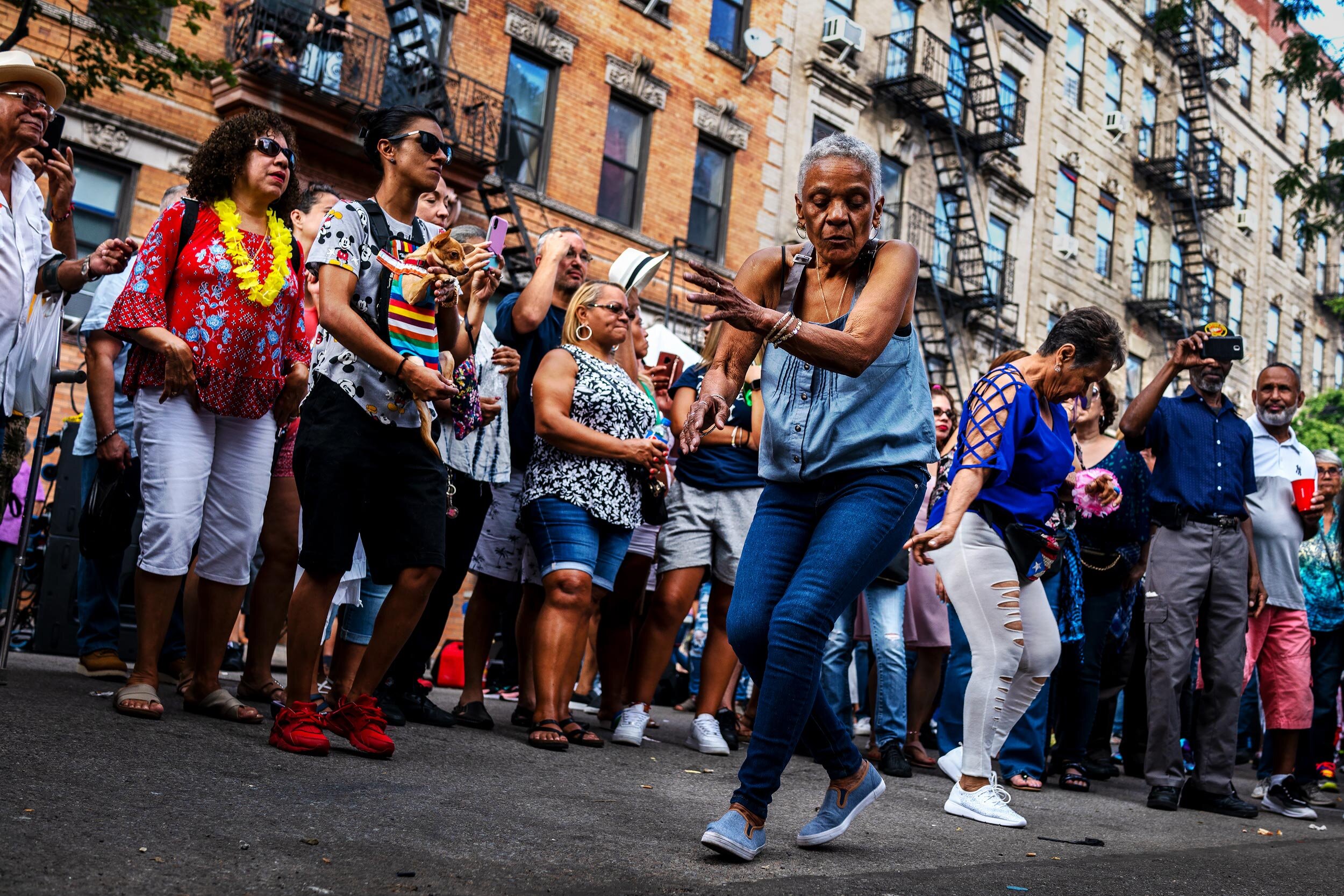  Dancing in the street to live music during the Annual South Side United Block party in Brooklyn, New York. Friends from the 70's, 80's, and 90's gather to celebrate peace and the unity of their community. Williamsburg’s Southside, also known in Span