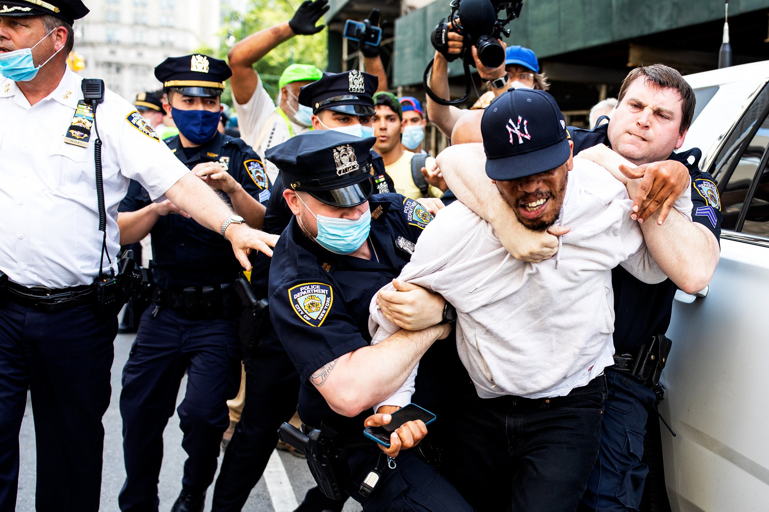  NYPD Police officers grab a protester following an altercation during a solidarity rally for George Floyd in Manhattan, New York.  