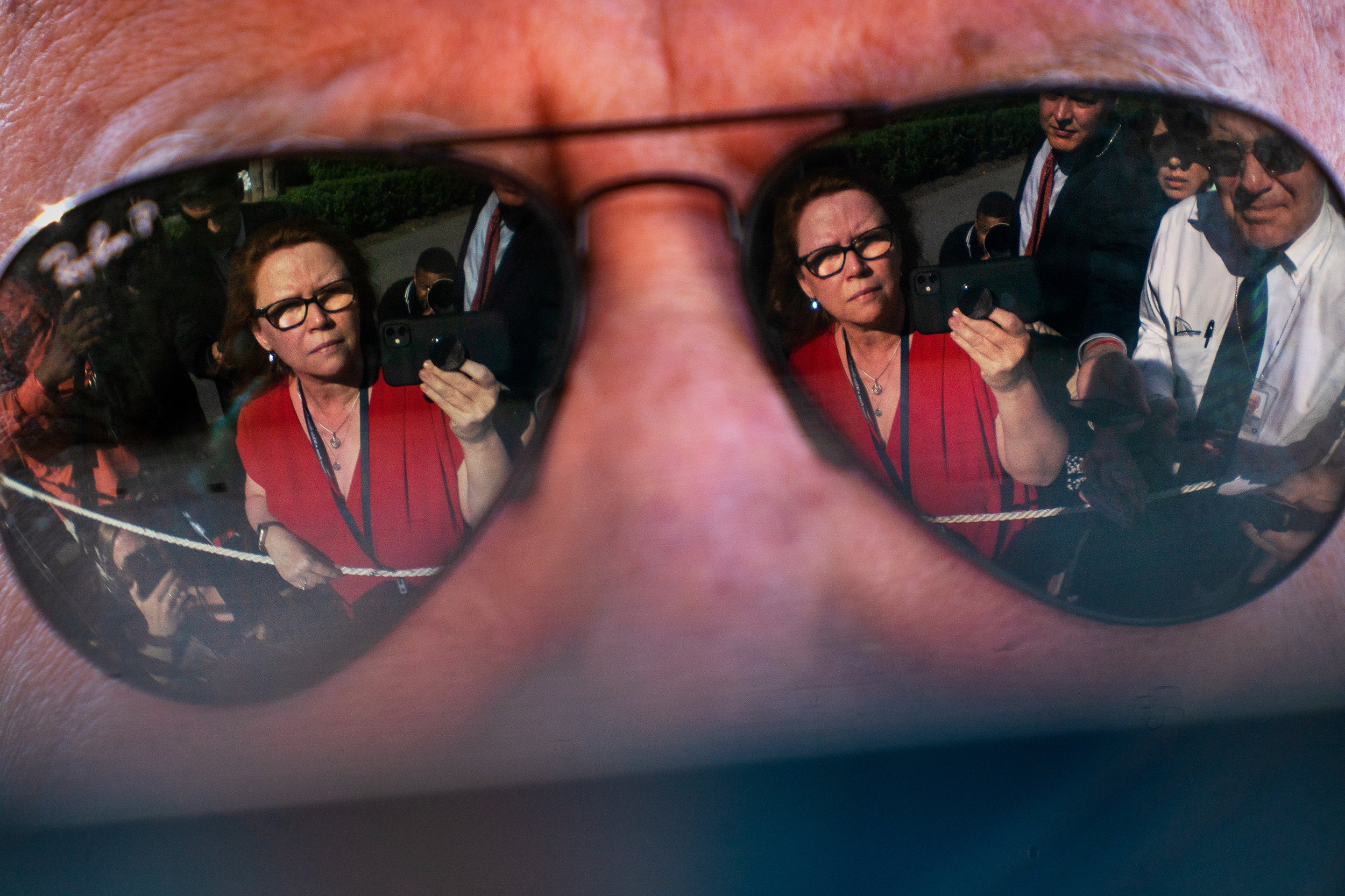  The reflections of the press pool in the sunglasses of US President Joe Biden. 