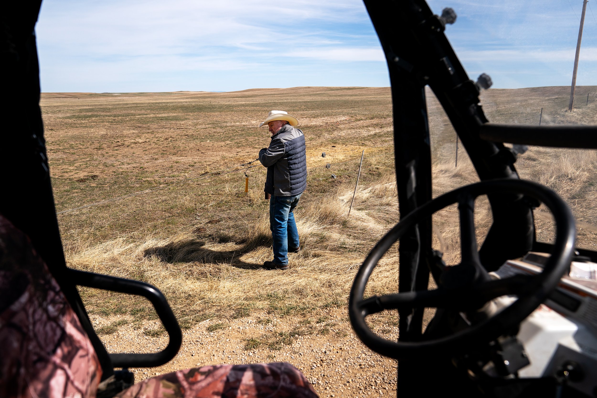  Butcher checks a barbed-wire fence while inspecting parts of the 12,000-acre family ranch. 