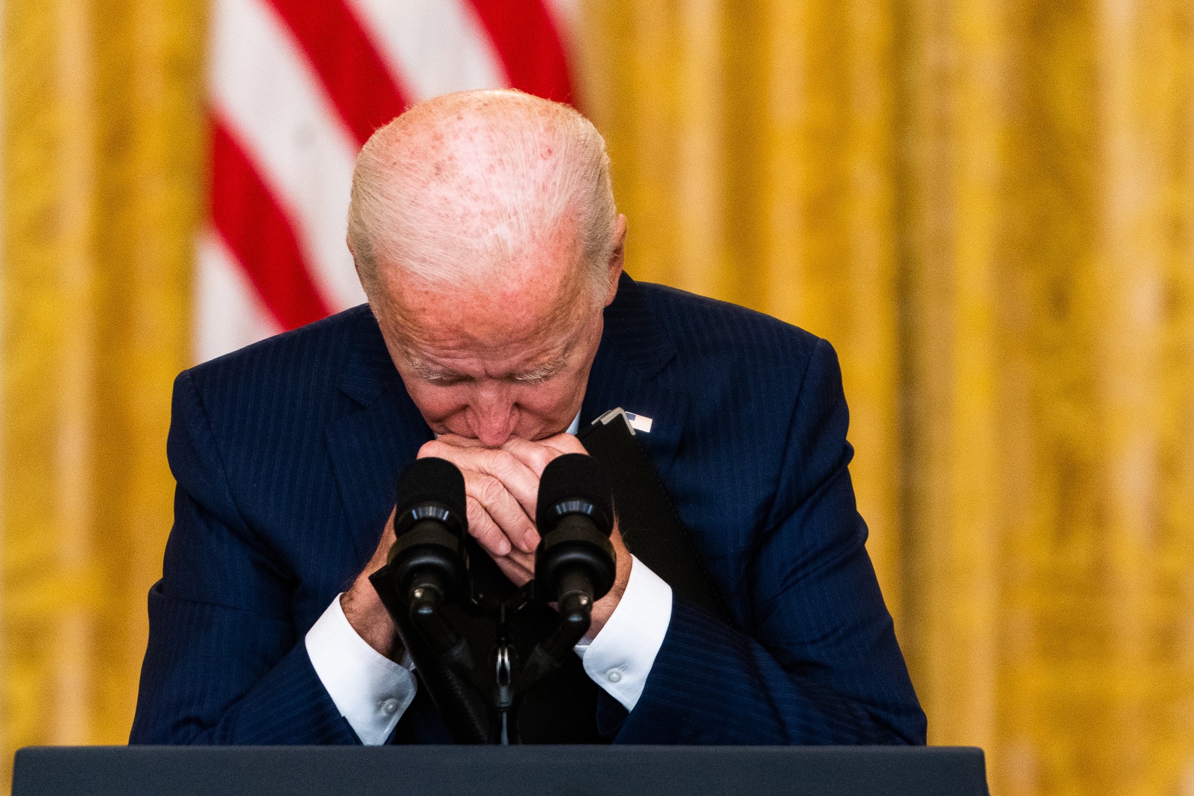  US President Joe Biden takes a moment during questioning following remarks regarding the 12 U.S. service members killed in a terrorist attack outside Kabul airport in the East Room at the White House. 