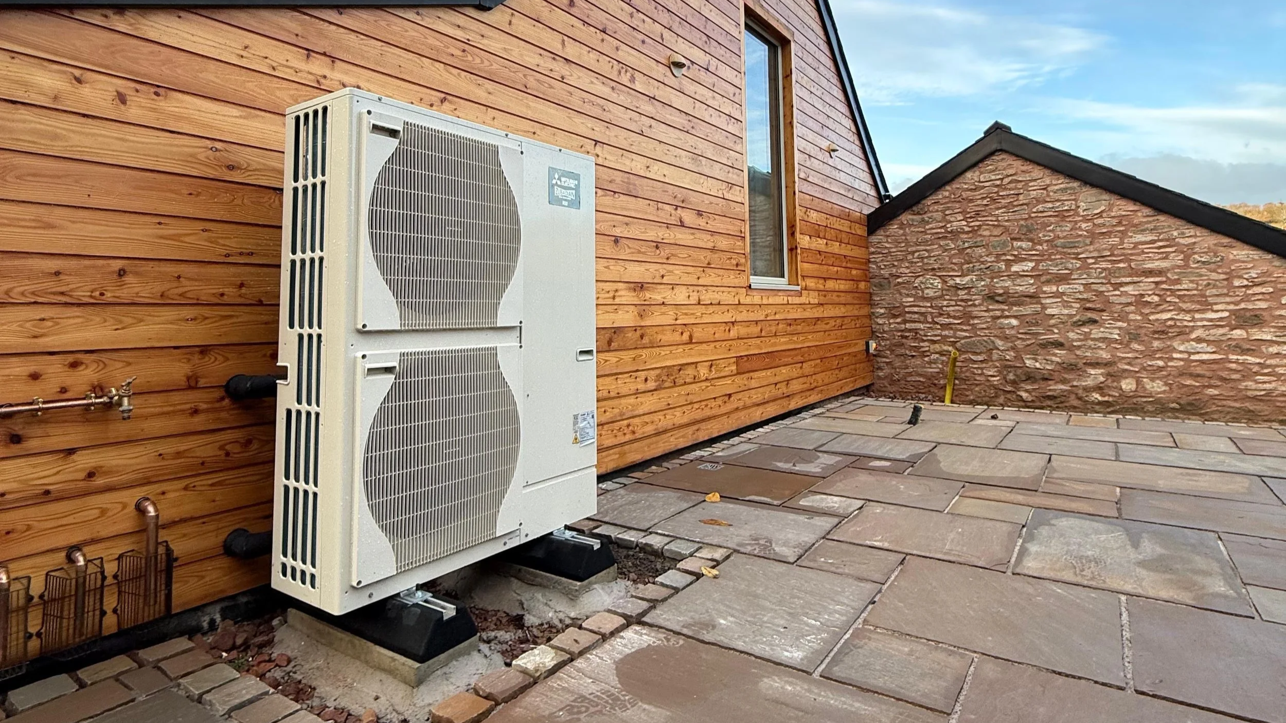 A Mitsubishi air source heat pump, a key renewable technology supported by the UK Government’s newly launched £15 billion Warm Homes Plan.