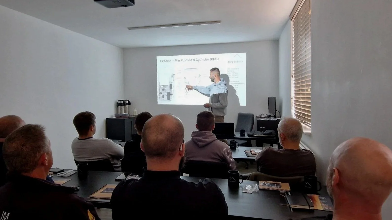 Alto Energy’s lead engineer explaining heat pump training course slides to installers