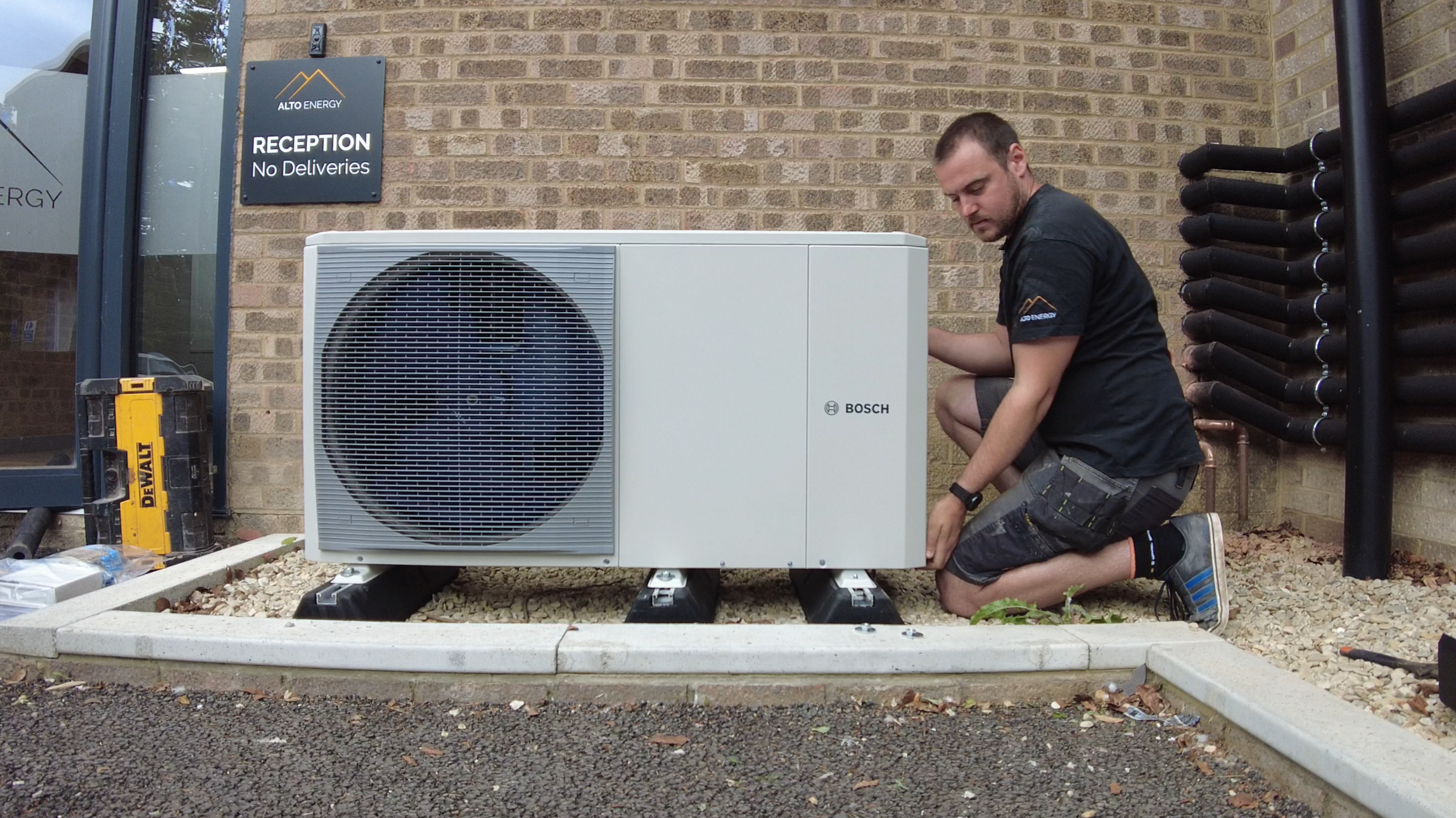 Alto Energy Partner installers fitting a heat pump as part of hands-on heat pump training course.