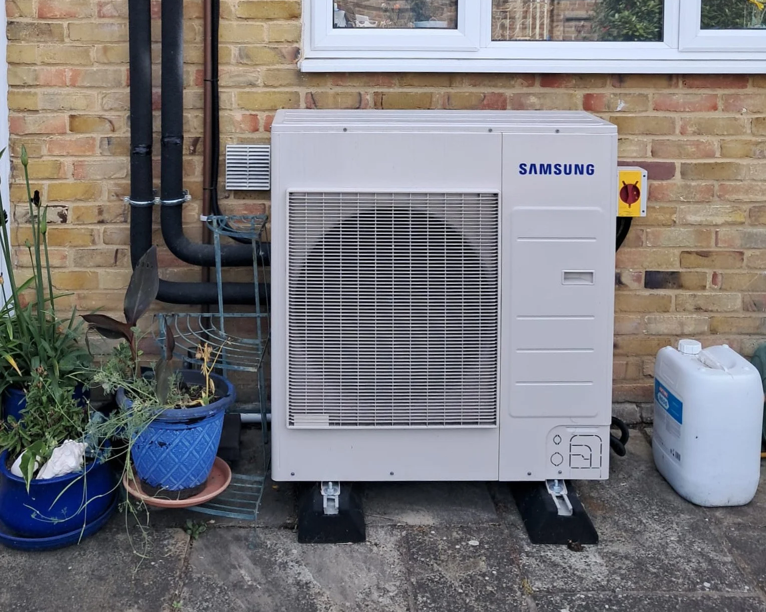 Samsung air source heat pump installed in an older home to provide efficient heating and comfort
