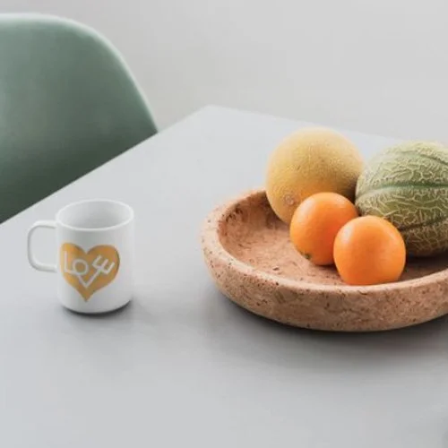 Designer porcelain mug featuring Girard’s 1961 Love Heart symbol in radiant gold.