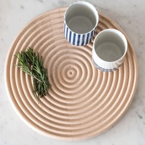 Modern wooden serving board and trivet featuring a digitally manufactured ripple pattern