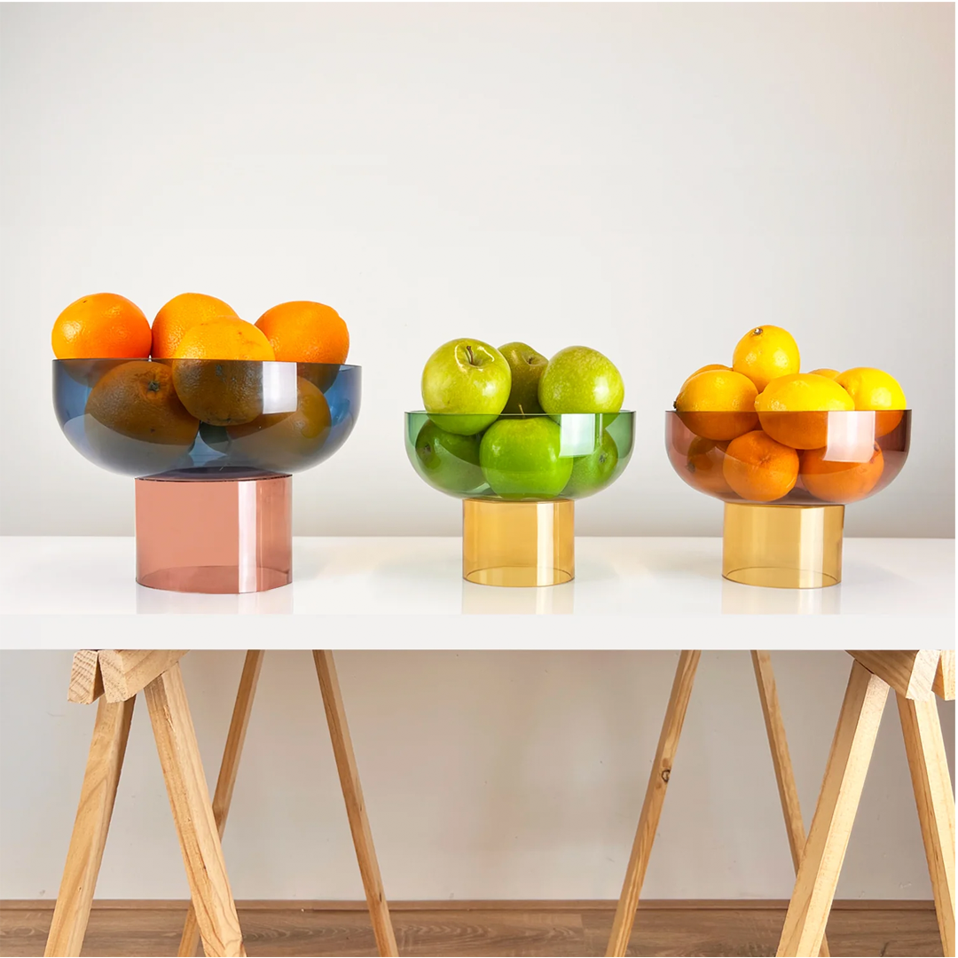 Modern decorative bowl crafted in translucent glass, an artful statement piece for any interior.