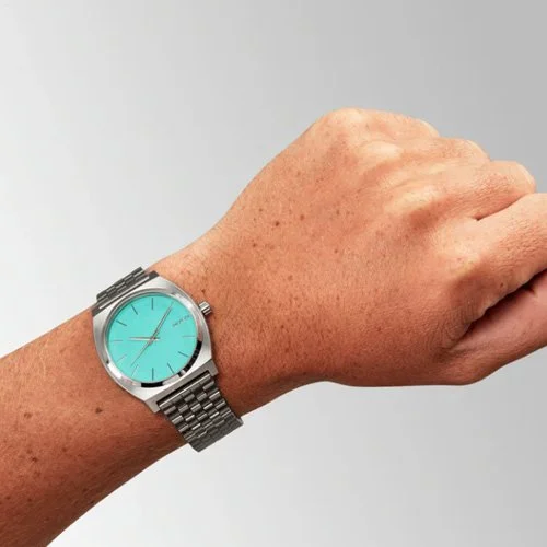 Nixon Time Teller watch in silver and turquoise with stainless steel bracelet