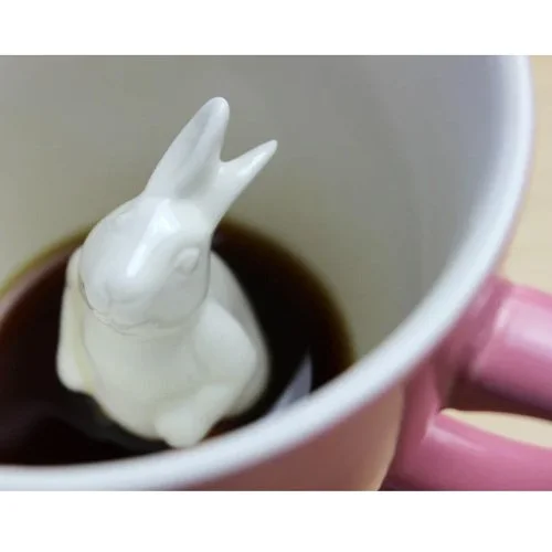 Blush pink Rabbit Coffee Cup by Creature Cups with hidden rabbit figure inside.