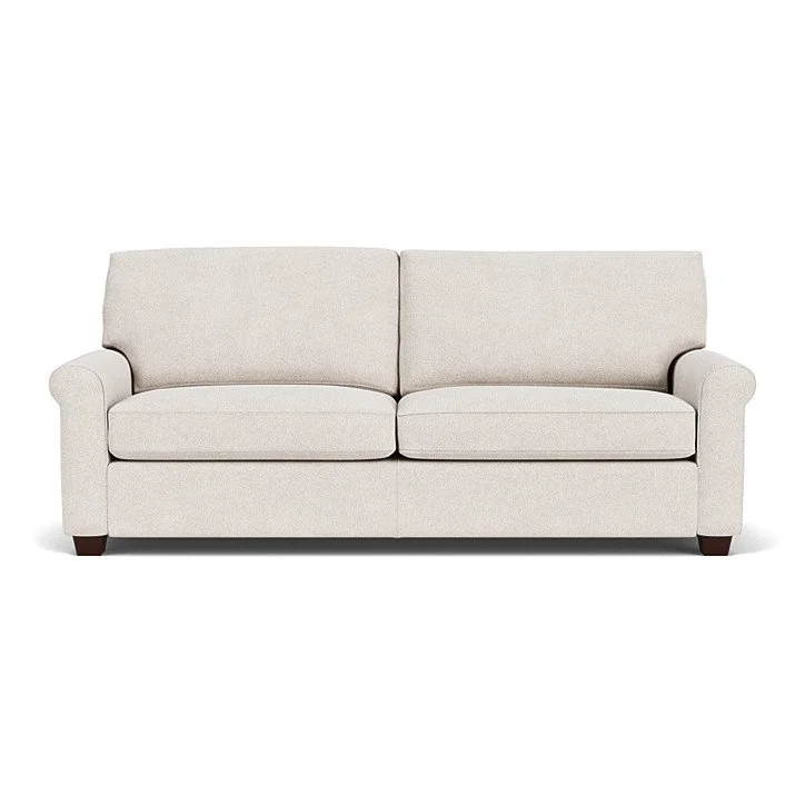 Savoy Sofa by American Leather with welt cord arms, loose cushions, and wood legs in a warm, modern interior. (Copy)