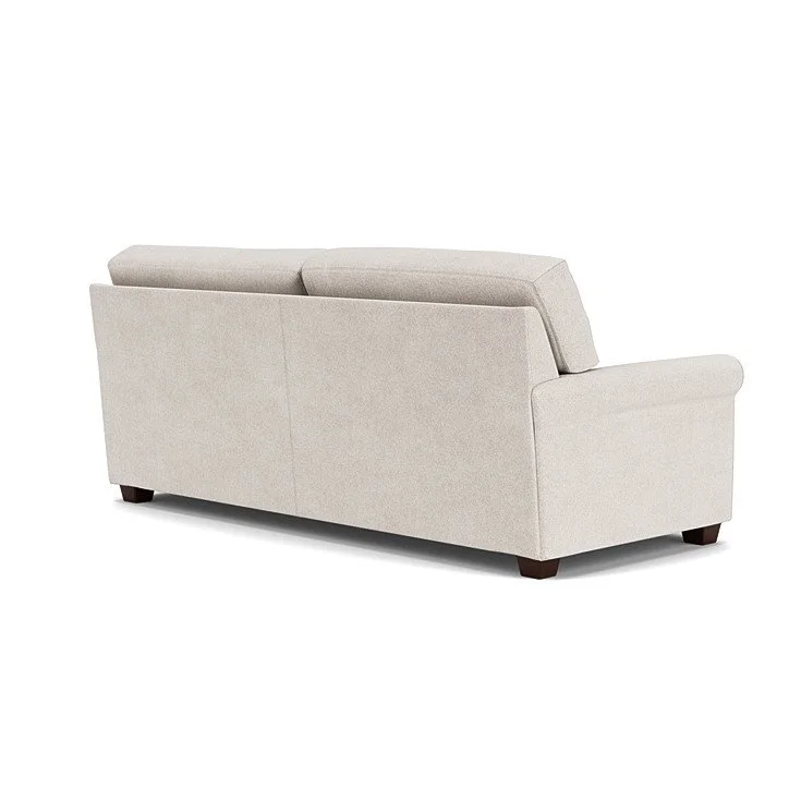 Savoy Sofa by American Leather with welt cord arms, loose cushions, and wood legs in a warm, modern interior.