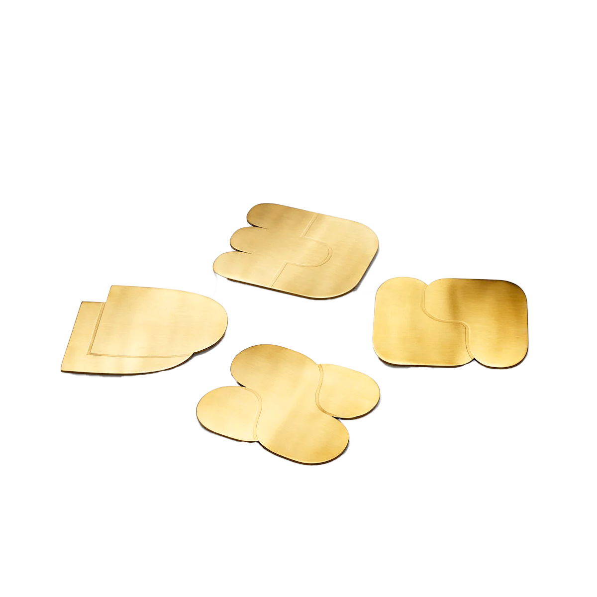 Areaware Together Coasters by Dan Covert with interlocking brass-finished shapes and cork backing.