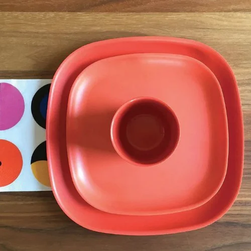 Vibrant orange dinnerware crafted for sustainable, stylish homes.