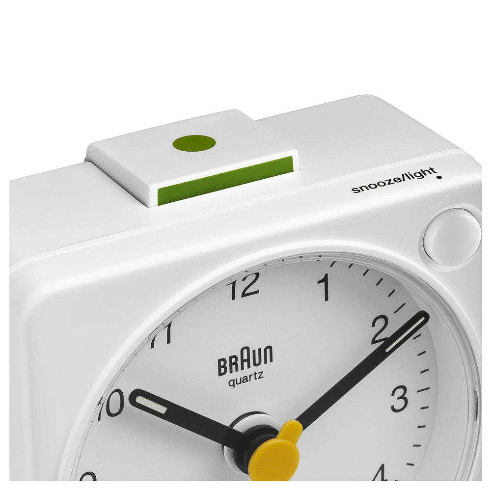 Compact white Braun clock with crescendo alarm—modern design classic for home and travel.