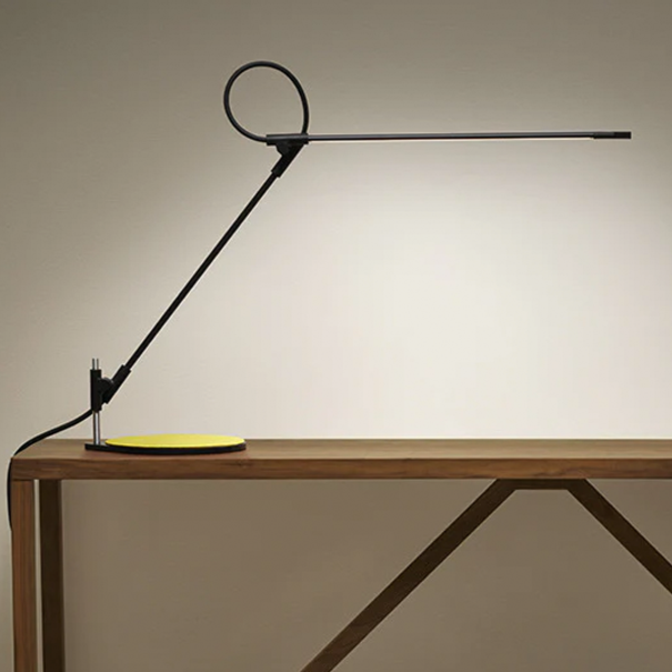Black articulated LED desk lamp with precise light control and technical motion.