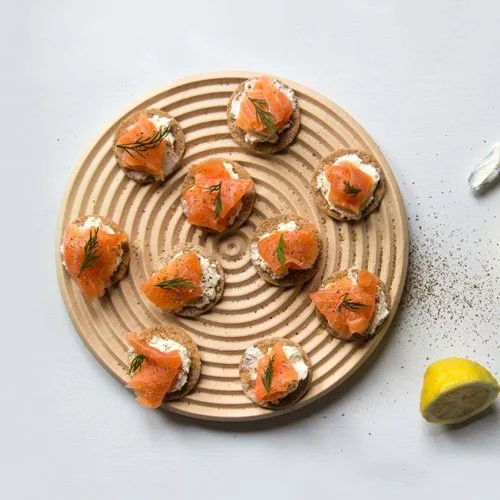 Sculptural beech kitchen accessory for chopping, serving, and protecting dining surfaces