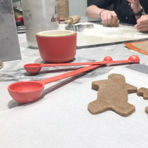 Eco-friendly red measuring spoons crafted from durable bamboo fiber and melamine.