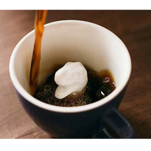 Cobalt blue T-Rex Coffee Cup by Creature Cups with sculpted dinosaur inside.