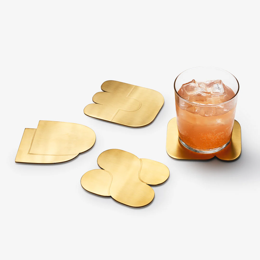 Weighty brass-finished coaster set that protects surfaces and adds contemporary style.