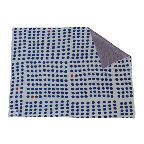 Modern blue circle throw, machine washable and made in the USA for sustainable comfort.