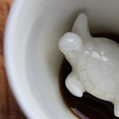 Playful, dishwasher-safe coffee mug with animal surprise at the bottom.