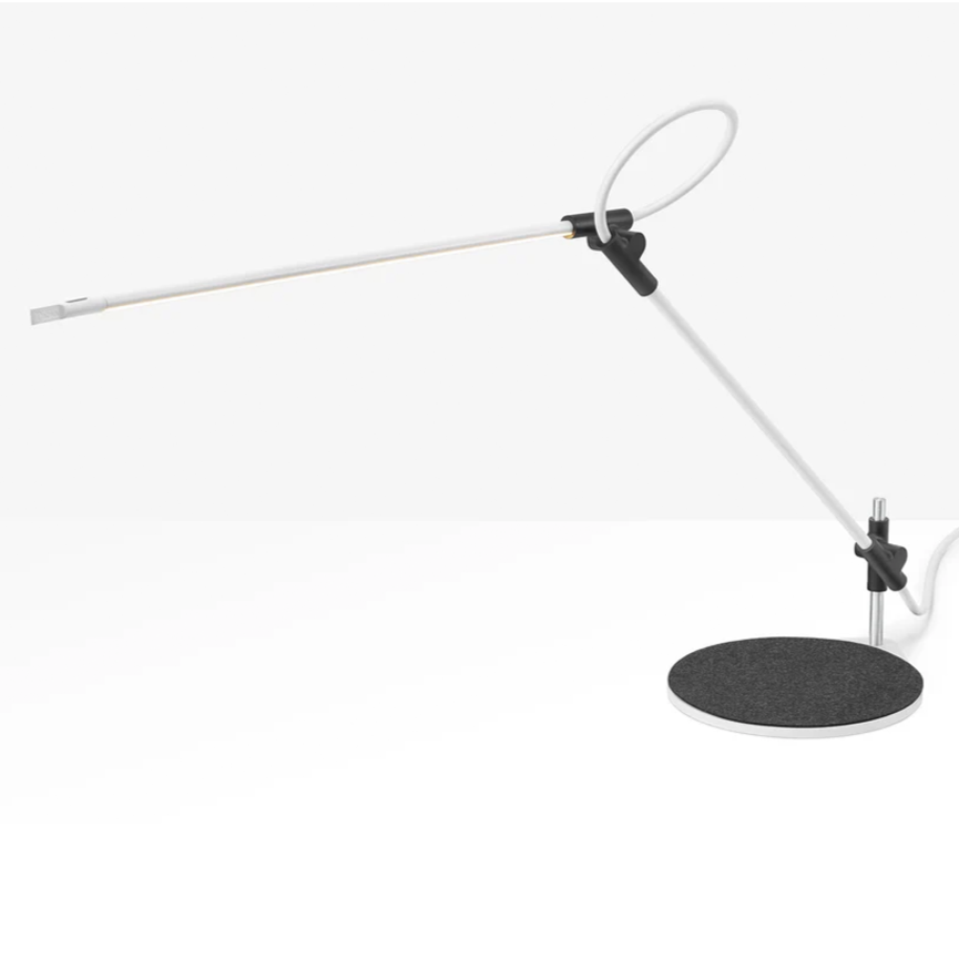 Contemporary white lamp offering technical articulation and efficient task lighting.
