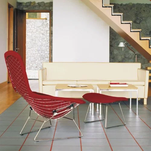 Iconic Bertoia design featuring arched wire form and bold red upholstery.