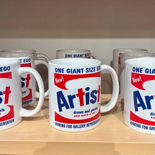 White ceramic mug with bold red and blue “ONE GIANT SIZE EGO” text in a pop-graphic style.