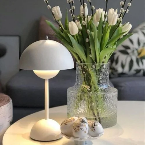 Modern neutral-toned lamp offering portable design and clean sculptural presence.