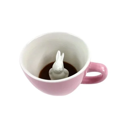 Blush pink Rabbit Coffee Cup by Creature Cups with hidden rabbit figure inside.