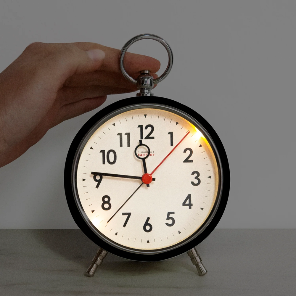 Modern black alarm clock featuring loud alarm and push-button light for night viewing.