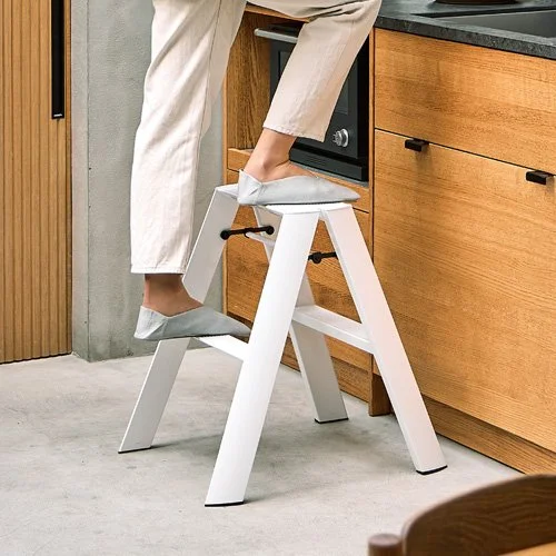 Minimalist two-step stool combining form and function for modern interiors.
