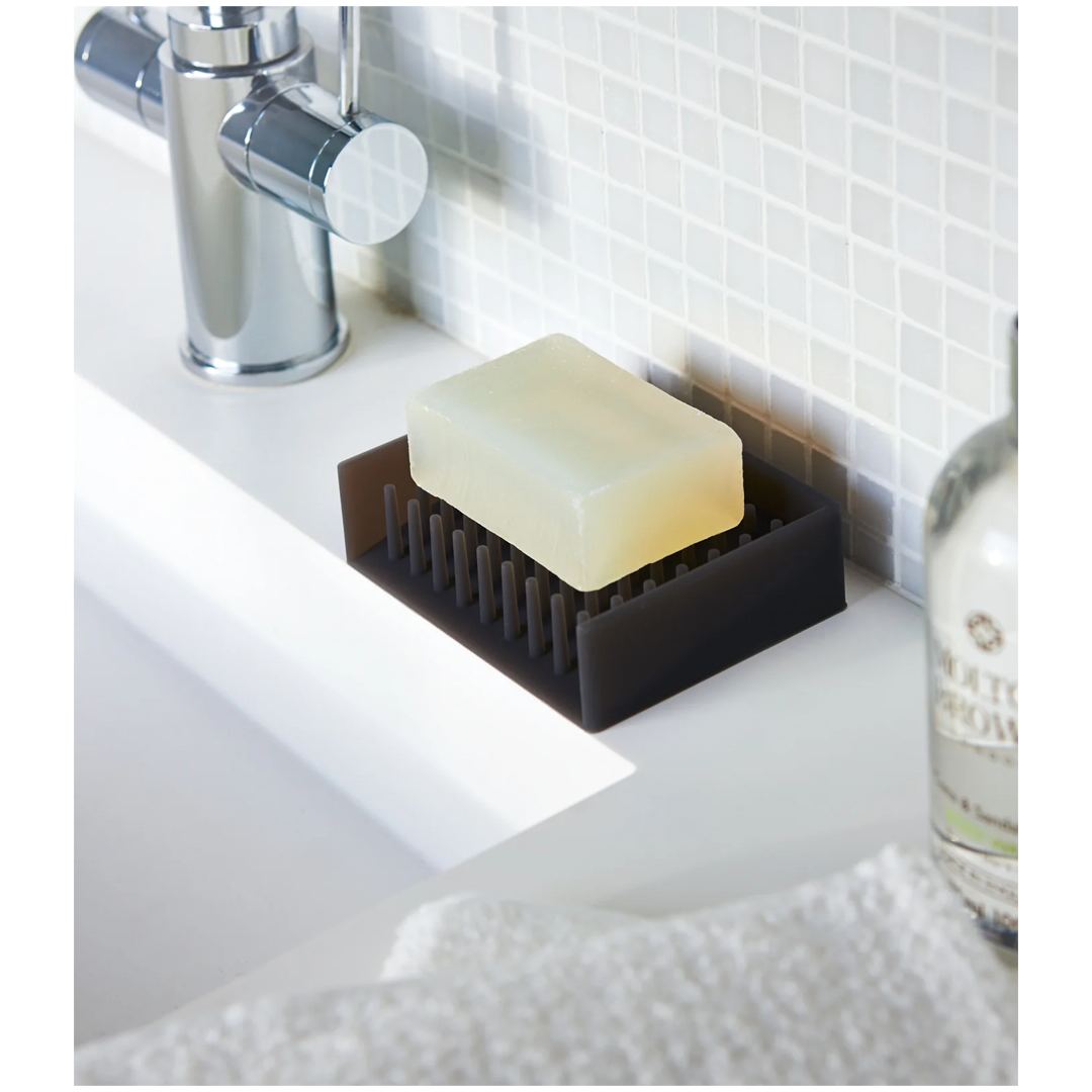 Modern self-draining soap dish that keeps bars dry and sinks clutter-free.