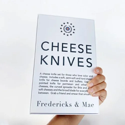 Playful mixed-material cheese knives with strong modern design and hosting-focused SEO terms.