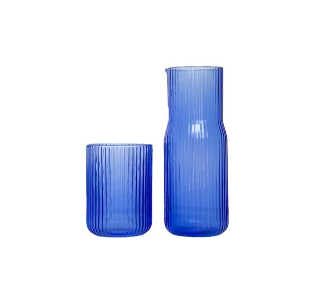 Gry Mattr Ribbed Carafe in Pool blue borosilicate glass adds sculptural elegance to modern dining.