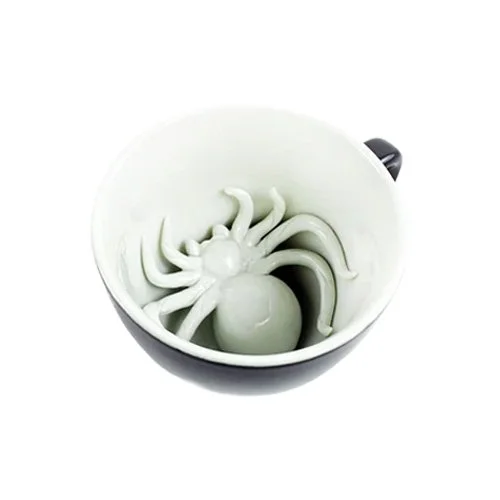 Matte black Spider Coffee Cup by Creature Cups with sculpted spider inside.