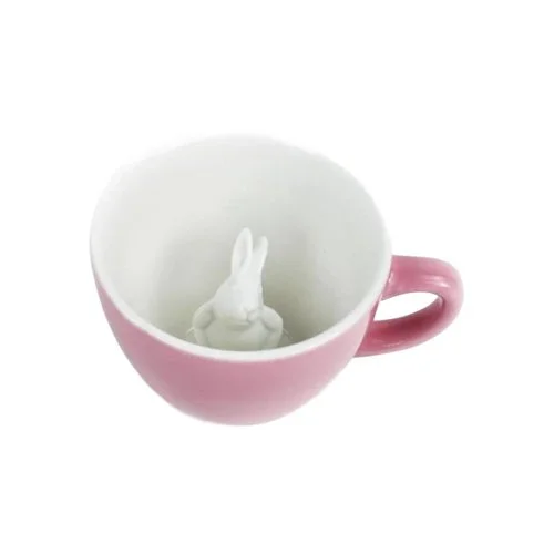 High-fire ceramic mug in soft pink with sculpted animal surprise.