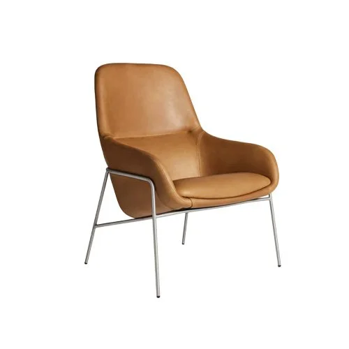 Modern leather lounge chair with natural patina and architectural structure.