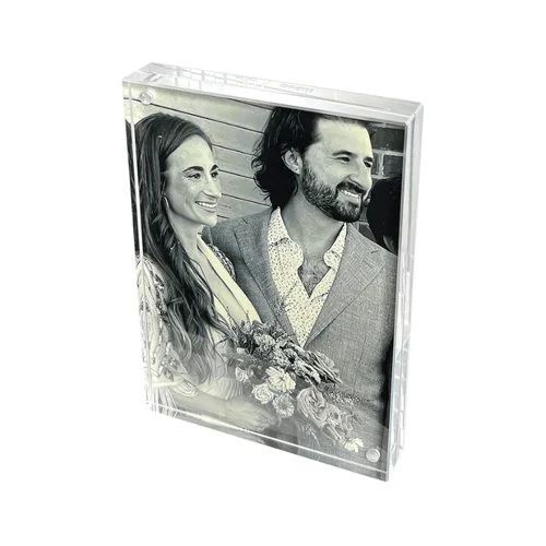 Crystal-clear acrylic photo frame by Canetti with a frameless, magnetic design for a sleek, floating photo display.