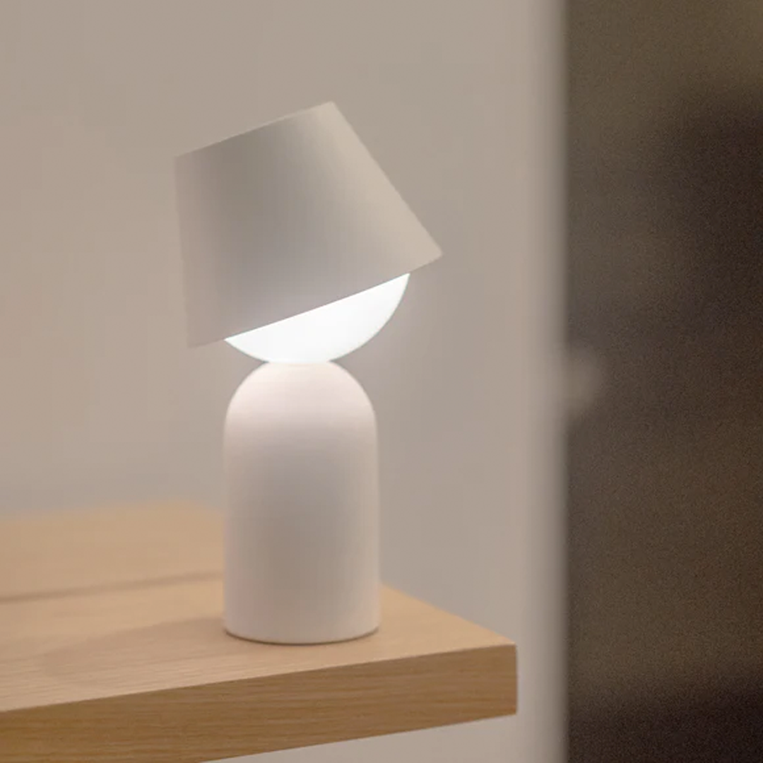 Rechargeable modern lamp offering warm diffusion and compact architectural design.