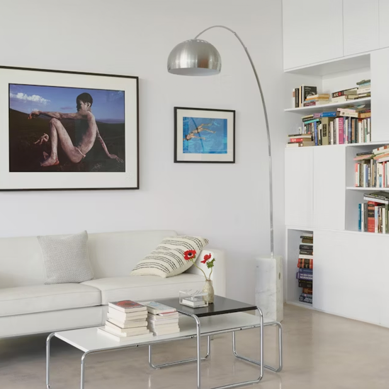 Iconic Castiglioni floor lamp featuring perforated reflector and controlled illumination.