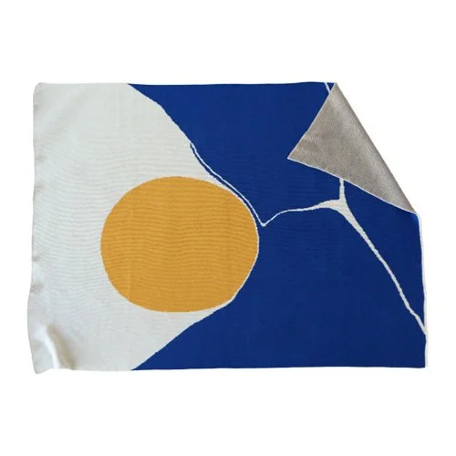 Modern, easy-care blanket adds quiet color to sofas, beds, and workspaces.