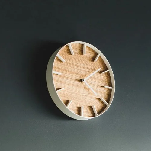 Modern wood wall clock with clean face and timeless style for contemporary interiors.