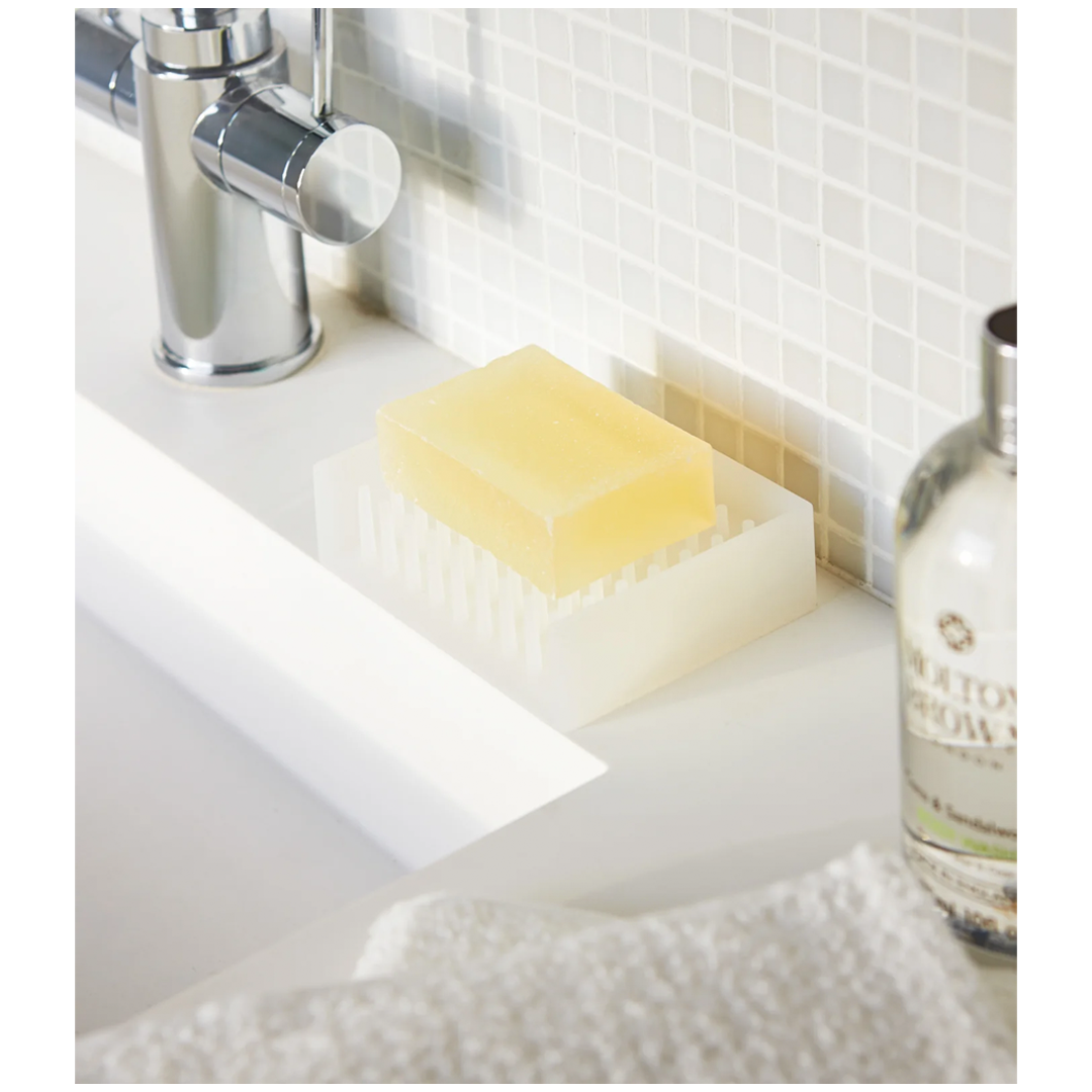 Modern soap dish with angled base for drainage, keeping soap clean and dry.
