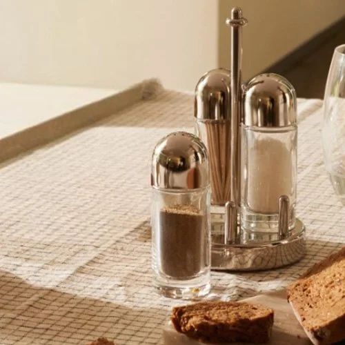 Alessi 5075 Salt Castor, durable stainless steel tabletop piece with clean cylindrical profile.